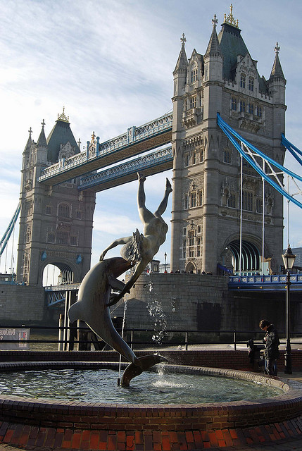 Dolphin statue and Tower Bridge, St Katherineâ€™s dock, London, England